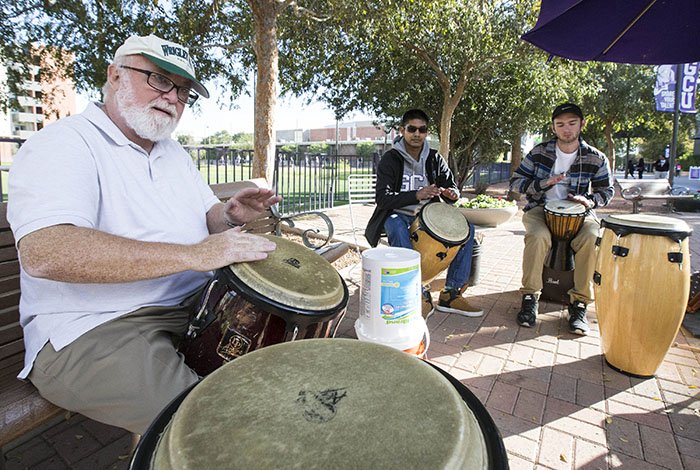 Dr. Larkin (left) invites anyone who wants to join him at the Thursday afternoon drum circle. 