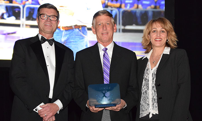 GCU President Brian Mueller (center) holds the Business Leader of the Year Award, which he received from Steven Zylstra (left), president/CEO of the Arizona Technology Council, and Sandra Watson, president/CEO of the Arizona Commerce Authority.