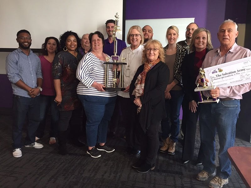 The Golden Turkey Trophy was ceremoniously presented to the employees who raised the most money during GCU's turkey drive. 